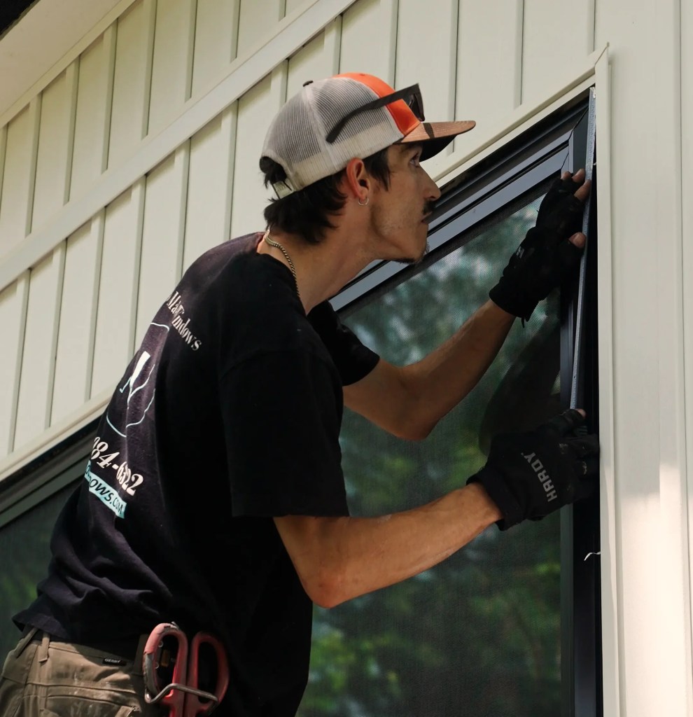 Window installer measuring a window