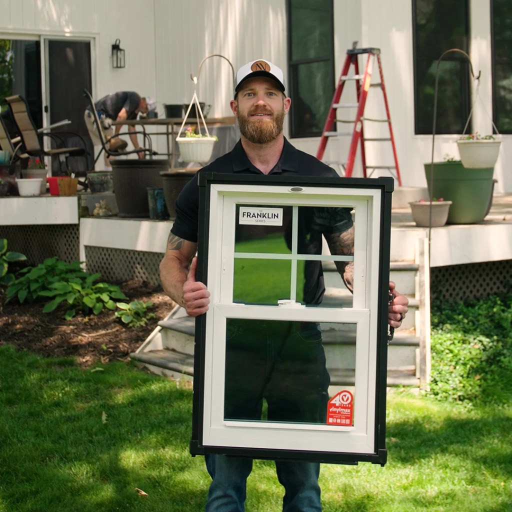 Nate the owner of virtual view windows holding a quality window panel